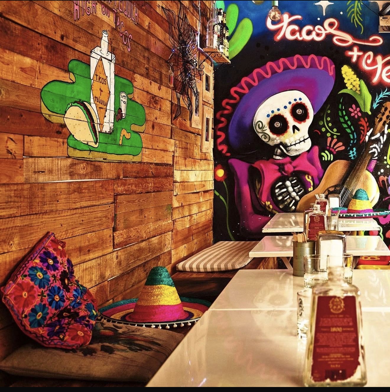 Interior of Holy Guacamoly restaurant with colourful mural